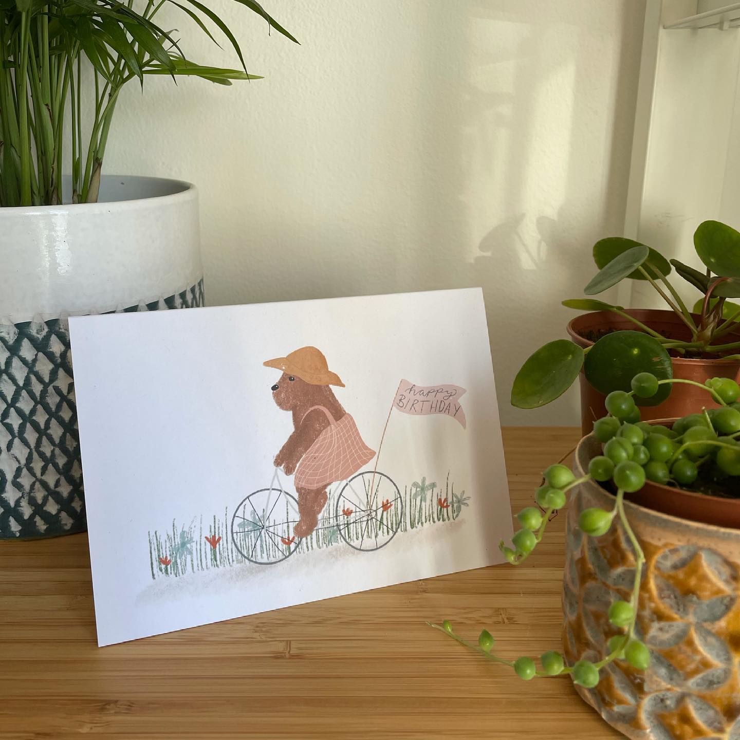 An image of a Happy Birthday Card with a bear cycling, illustrated by Hello You Create.